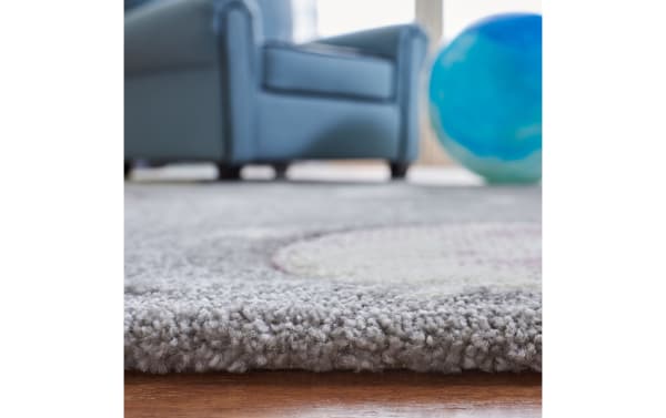 Cosmic Galaxy 3' x 5' gray transitional rug with playful planets and stars pattern, made of durable polypropylene and polyester blend.