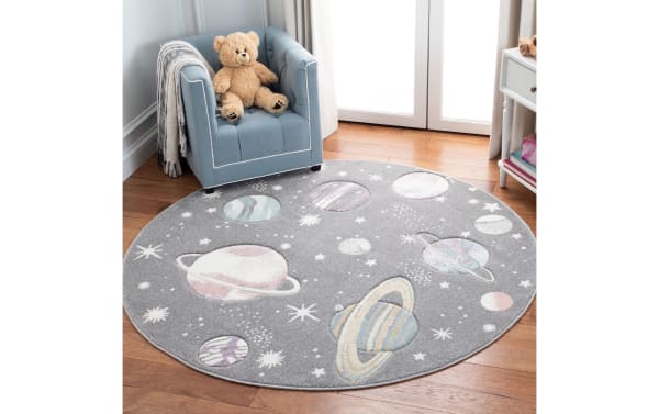 Cosmic Galaxy 3' round gray transitional rug with playful lavender planets and stars pattern, made of durable polypropylene and polyester blend.