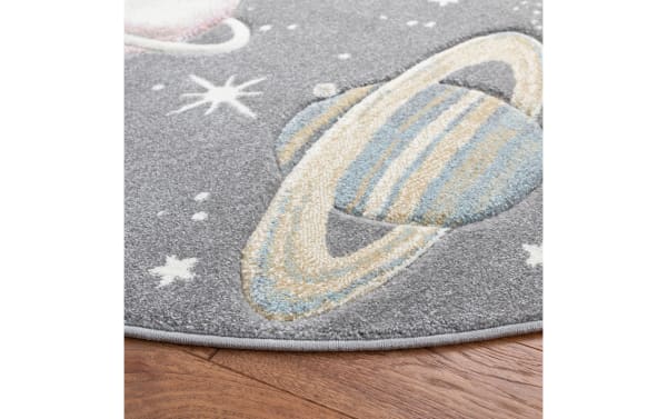 Cosmic Galaxy 3' round gray rug with playful planets and stars pattern, transitional style, durable polypropylene pile, cozy and easy to clean.