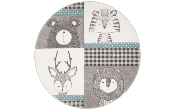 Forest Friends 4' round transitional rug with light blue, gray, and ivory colors featuring cute animal faces. Made of durable polypropylene, polyester, jute, and latex, power-loomed for softness and resilience, ideal for kids' rooms.
