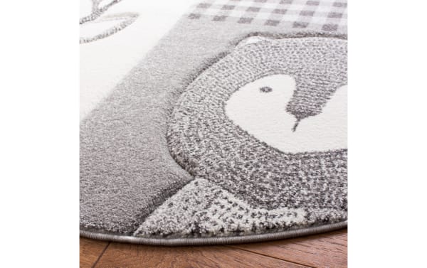 Close-up of Forest Friends 4' round transitional rug in gray, ivory, and light blue, made of durable polypropylene with soft, textured animal design.