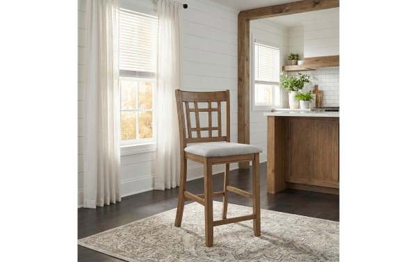 Brookside Brown & Light Gray Upholstered Counter Stool with solid wood frame, slatted back, oak veneer finish, and padded light gray polyester seat in farmhouse style.