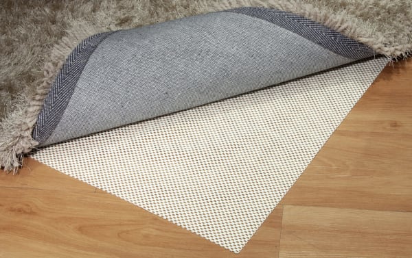Bob's 8' x 10' White Magic Rug Pad with non-slip polyester fabric backing, designed to prevent slipping and protect hardwood floors.