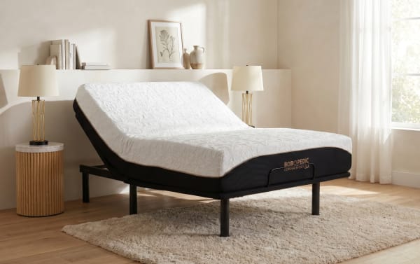 Adjustable bed with white textured Bob-O-Pedic Copper Sport Gel mattress, black base, wooden floor, beige walls, and natural light.