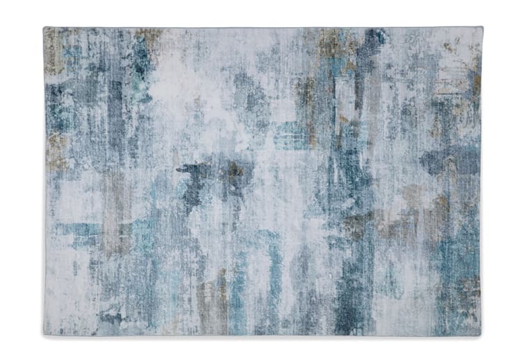 Modern abstract area rug with a distressed pattern in shades of blue, gray, and beige, featuring a soft textured surface ideal for living room or bedroom decor.