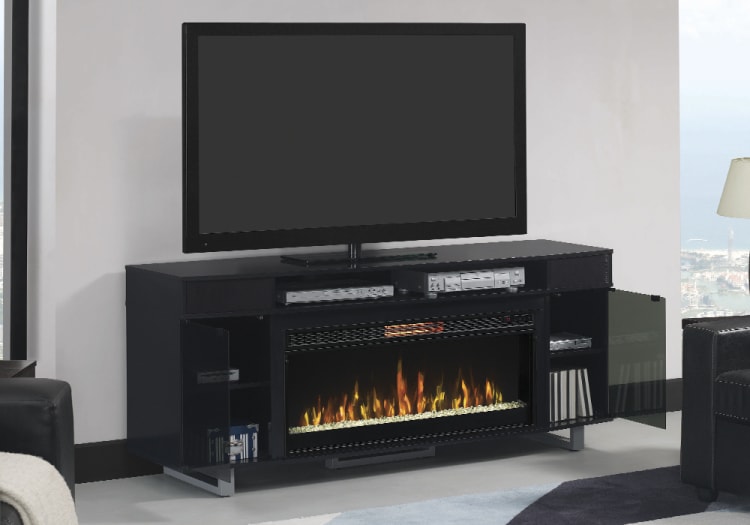 Black modern TV stand with electric fireplace insert, glass doors, and storage shelves, supporting a flat-screen TV and media devices.