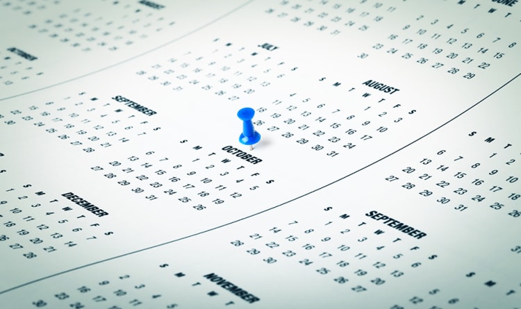 Calendar pages showing months July, August, September, October, November, and December with a blue pushpin marking October 18.