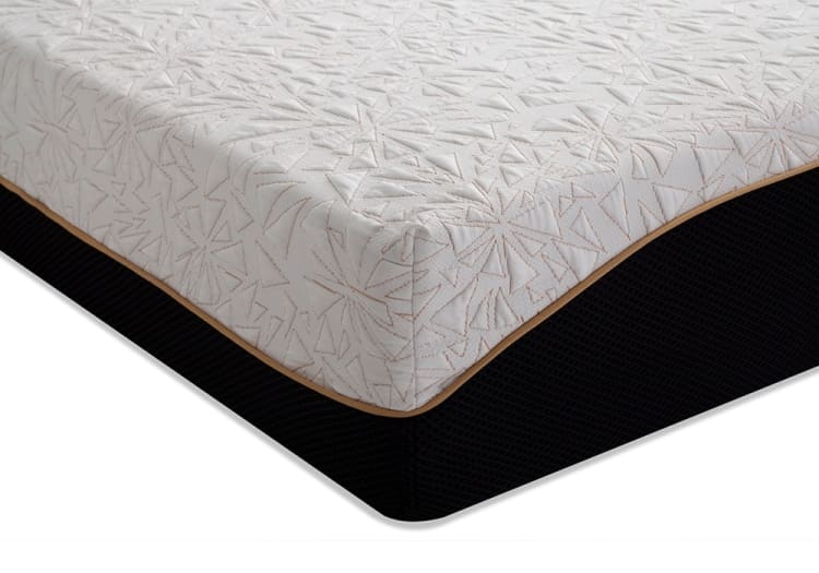 Mattress corner with a white quilted top featuring geometric stitching and a black textured base with tan piping, highlighting design and material details.