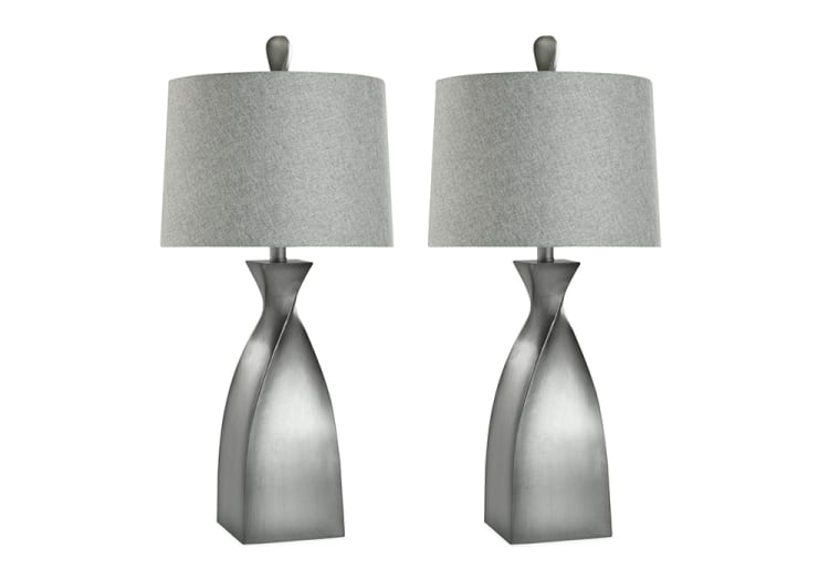 Pair of modern table lamps with twisted metallic silver bases and light gray fabric drum shades, ideal for contemporary home decor.