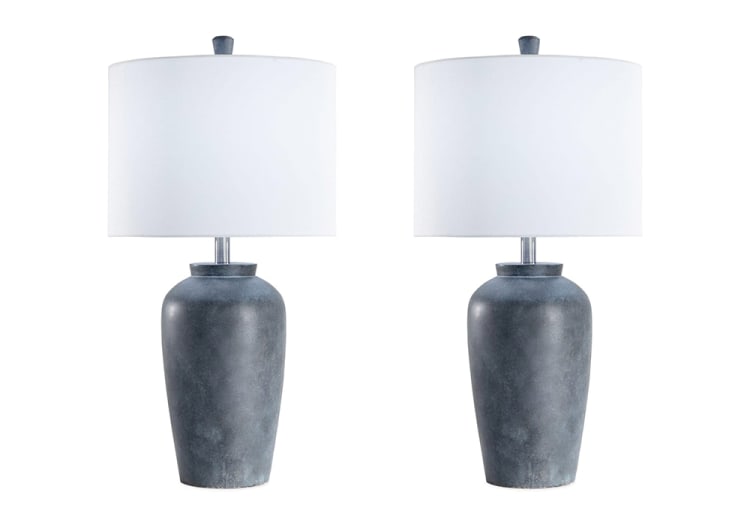 Pair of modern table lamps with matte gray ceramic bases and large white drum fabric shades, ideal for contemporary home decor lighting.