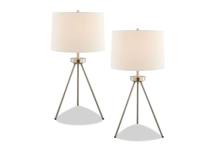 Set of two modern tripod table lamps with brushed metal bases and white fabric drum shades, ideal for contemporary home lighting.