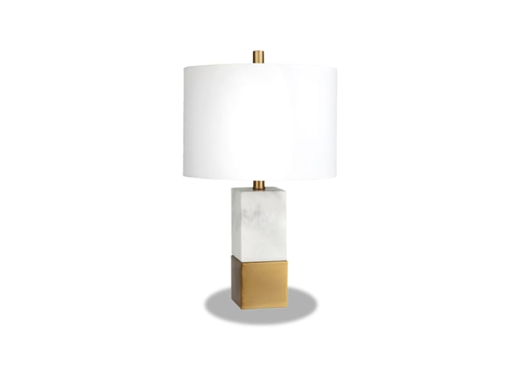 Modern table lamp with a white fabric drum shade, marble midsection, and brushed gold metal base, ideal for stylish home lighting.