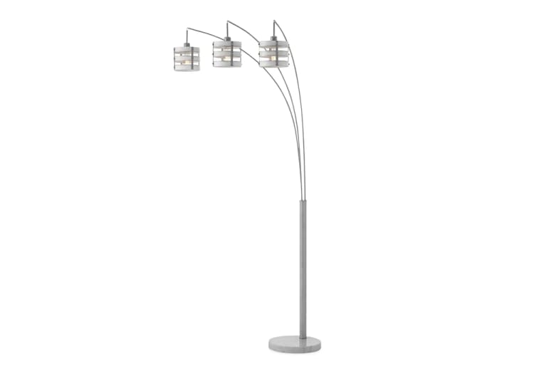 Modern arc floor lamp with three adjustable brushed nickel arms and cylindrical frosted glass shades, ideal for contemporary living rooms.
