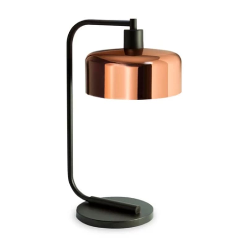 Modern table lamp with a black metal frame and a shiny copper dome-shaped shade, featuring a round base for stability.