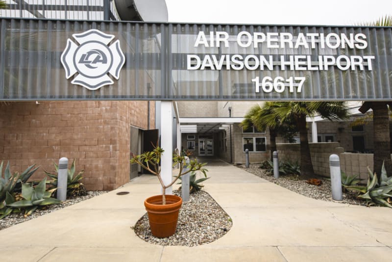Entrance to the LA Air Operations Davison Heliport 16617, featuring a concrete pathway, potted plant, and surrounding desert landscaping.