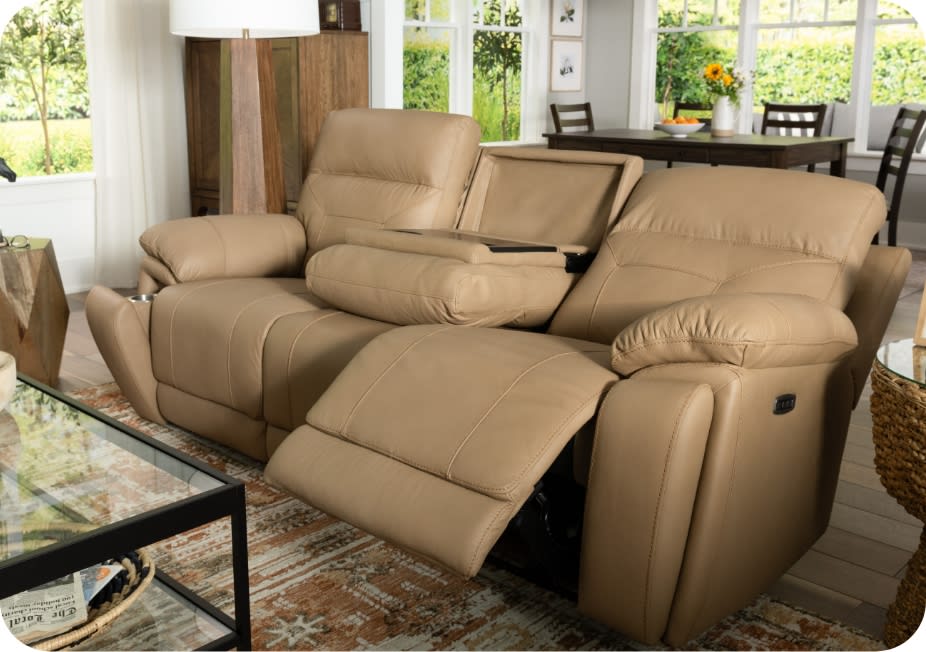 Beige leather reclining sofa with drop down table