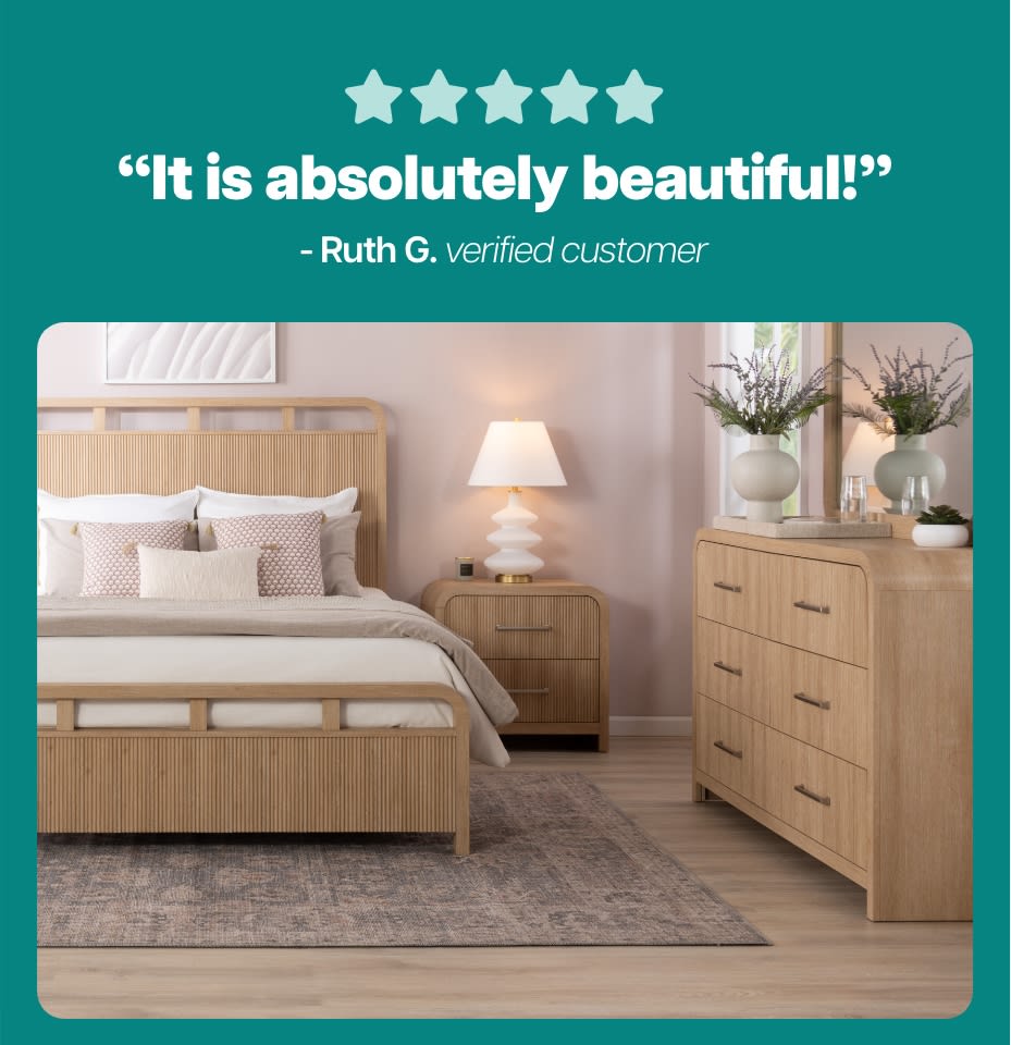 Five-star rating with the text: “It is absolutely beautiful!” - Ruth G. verified customer, above a modern bedroom set featuring light wood bed frame, nightstand, and dresser with decorative plants and a lamp.