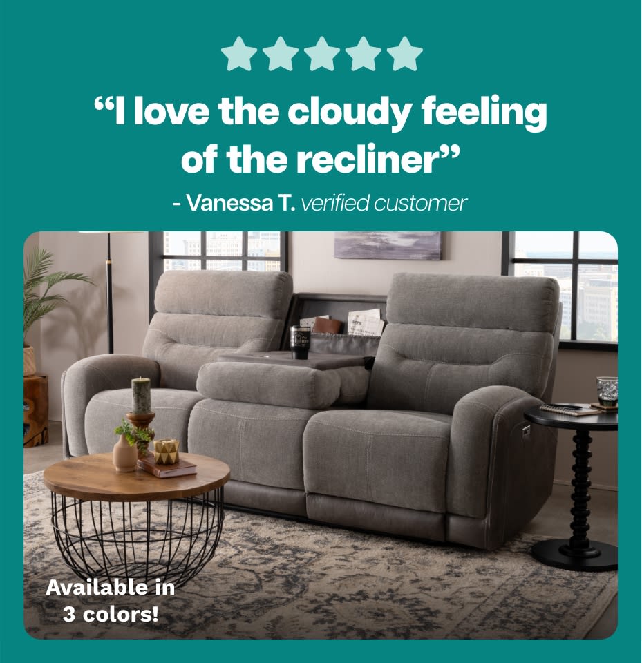 Five-star rating with the text: “I love the cloudy feeling of the recliner” - Vanessa T. verified customer. Below is a gray fabric reclining loveseat with plush cushioning, visible stitching, and two side tables. Text reads: Available in 3 colors!