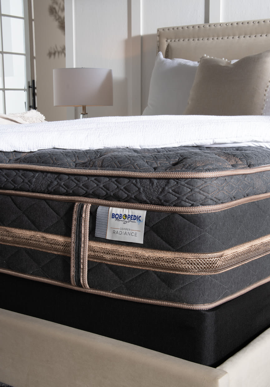 Tufted dark gray tufted mattress with beige trim