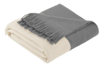 White and gray throw blanket folded with fringes on the bottom