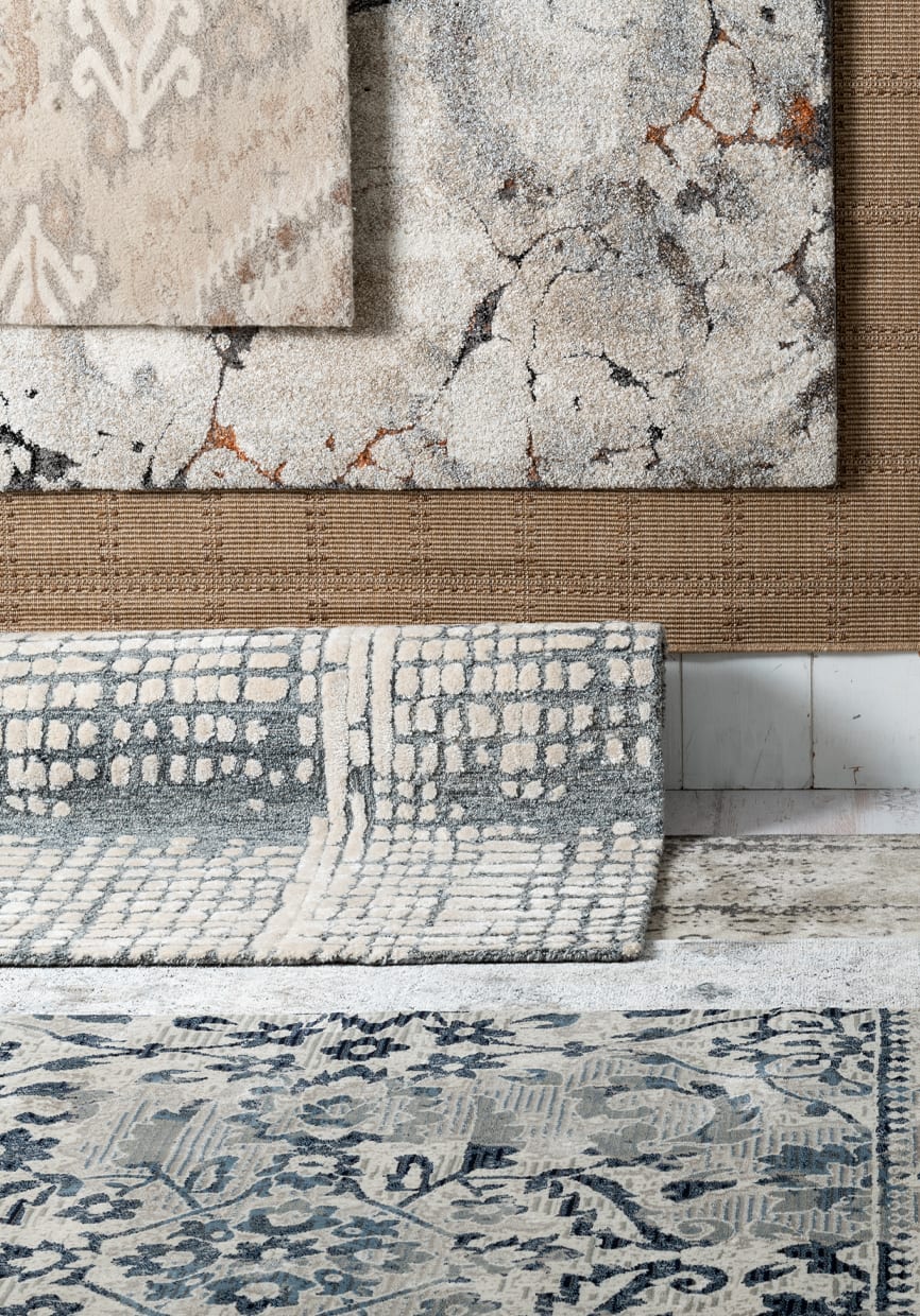 6 rugs in a variety of colors (blue, white, beige, and gray) and patterns