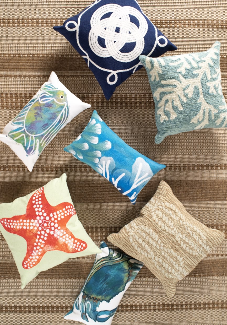 Coastal inspired square and lumbar outdoor accent pillows.