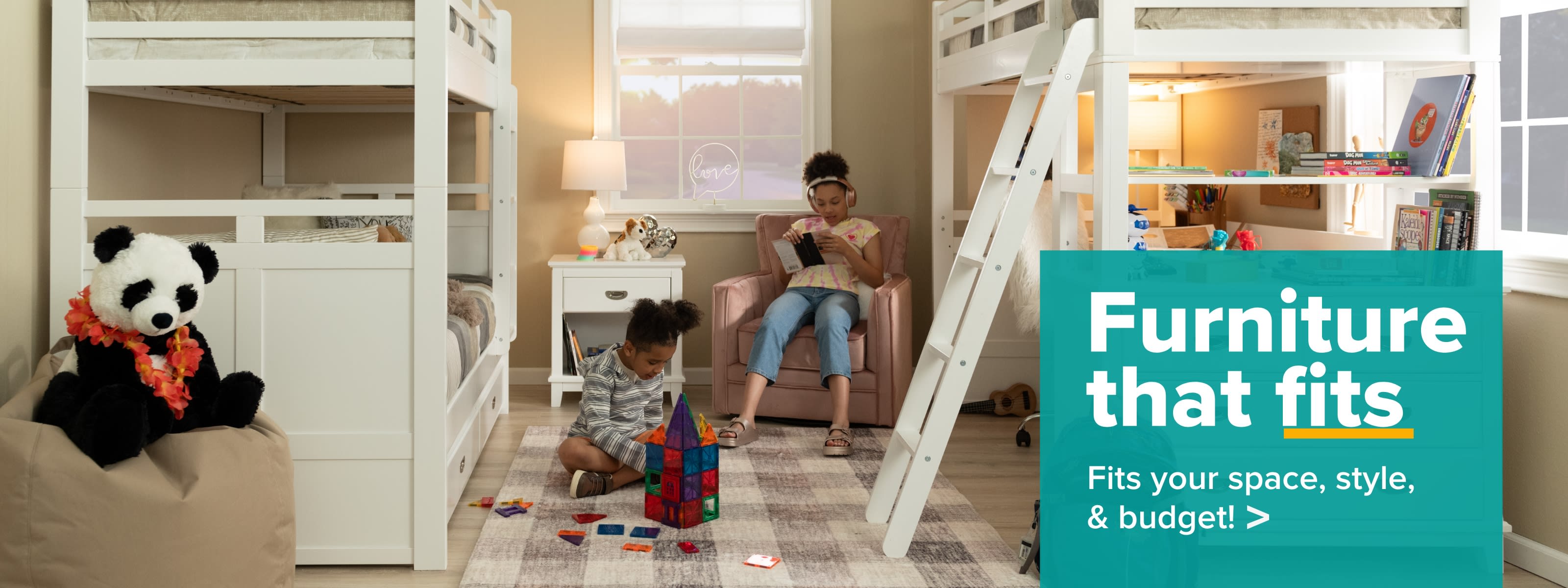 Kids room with a white bunk bed to the left with a nighstand and another white loft bed with desk to the right with a ladder. 2 kids in the middle with sitting on a kids chair and the other playing with blocks. Text Reads: Furniture that fits. Fits your space, style, and budget.