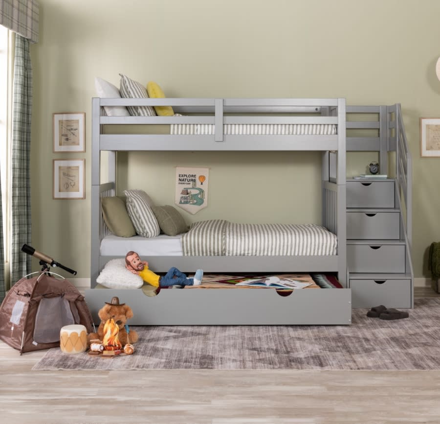 Gray twin size bunk bed with trundle bed and staircase storage centered on a gray abstract rug.