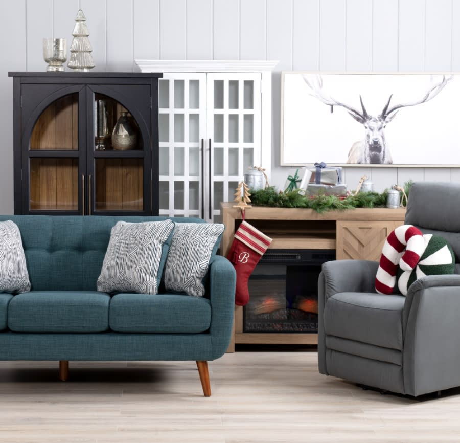 Teal sofa, gray recliner, fireplace and black accent storage