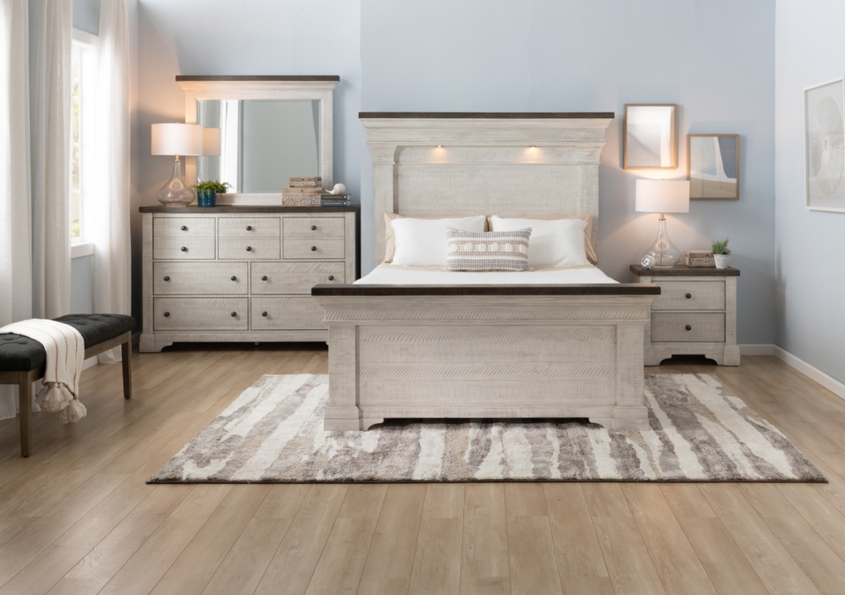 Hefty gray with brown trim bedroom set with bed featuring LED lights in the headboard, 6 drawer dresser with mirror, and 2 drawer nightstand anchored on a gray and white abstract rug with black upholstered bench.