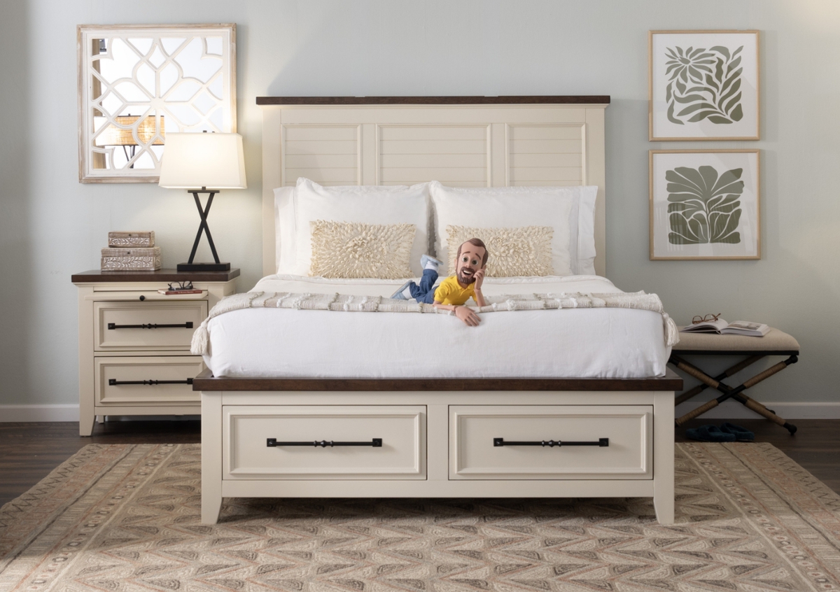 Transitional white with cherry trim and black hardware bedroom set with storage bed and 2 drawer nightstand, atop a brown ikat rug with reading stool.