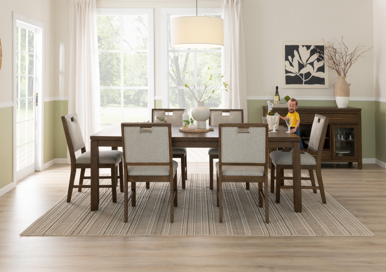 Dining room with light brown rectangular dining table with 6 brown and white slat back upholstered dining chairs and brown 4 door server.