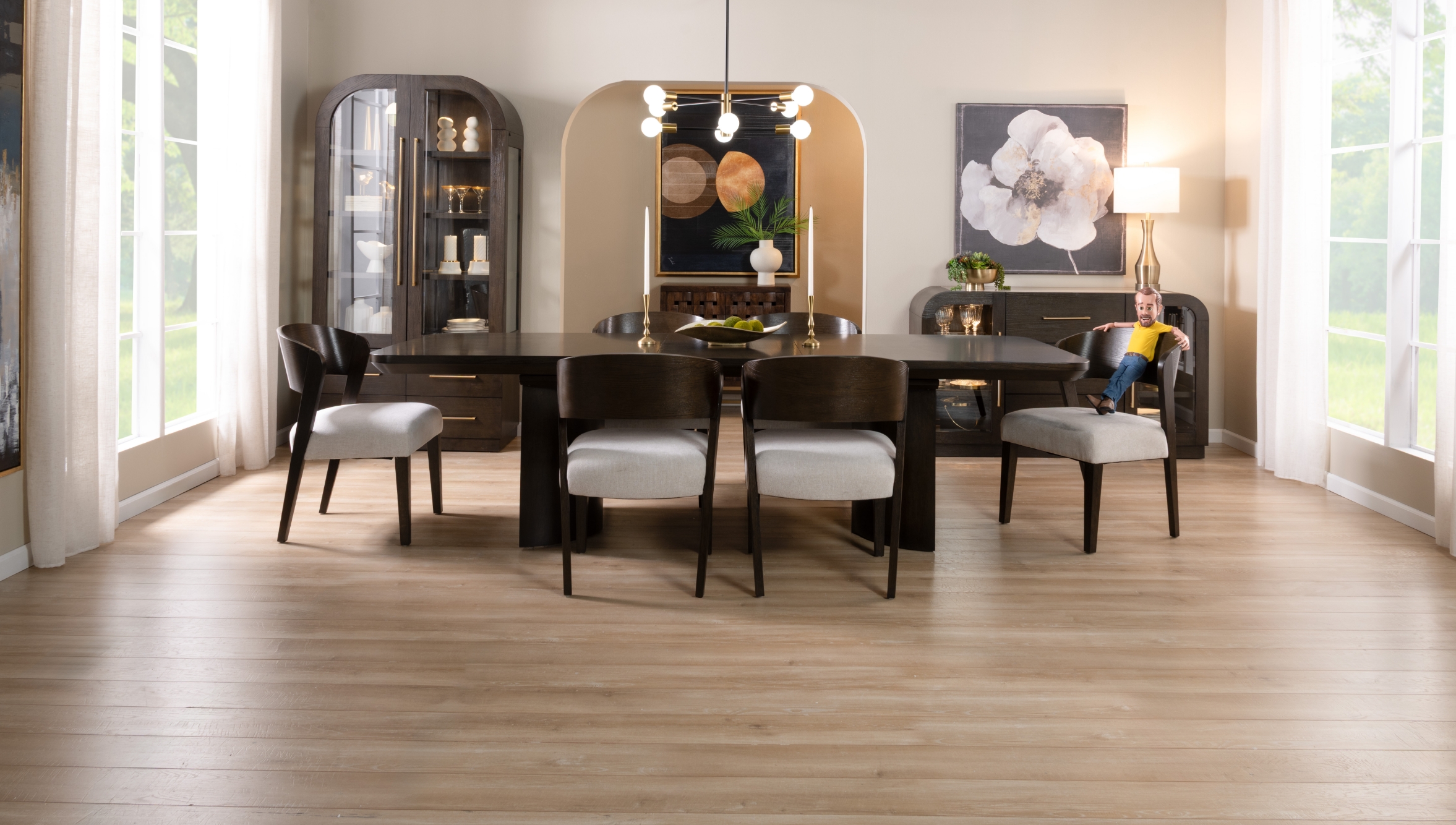 Luxurious contemporary dining set in a rich brown finish with white upholstered seats, in a light beige room featuring a tall two glass door china cabinet with 4 drawers, and a two glass door and 3 drawer server with beige marble top.