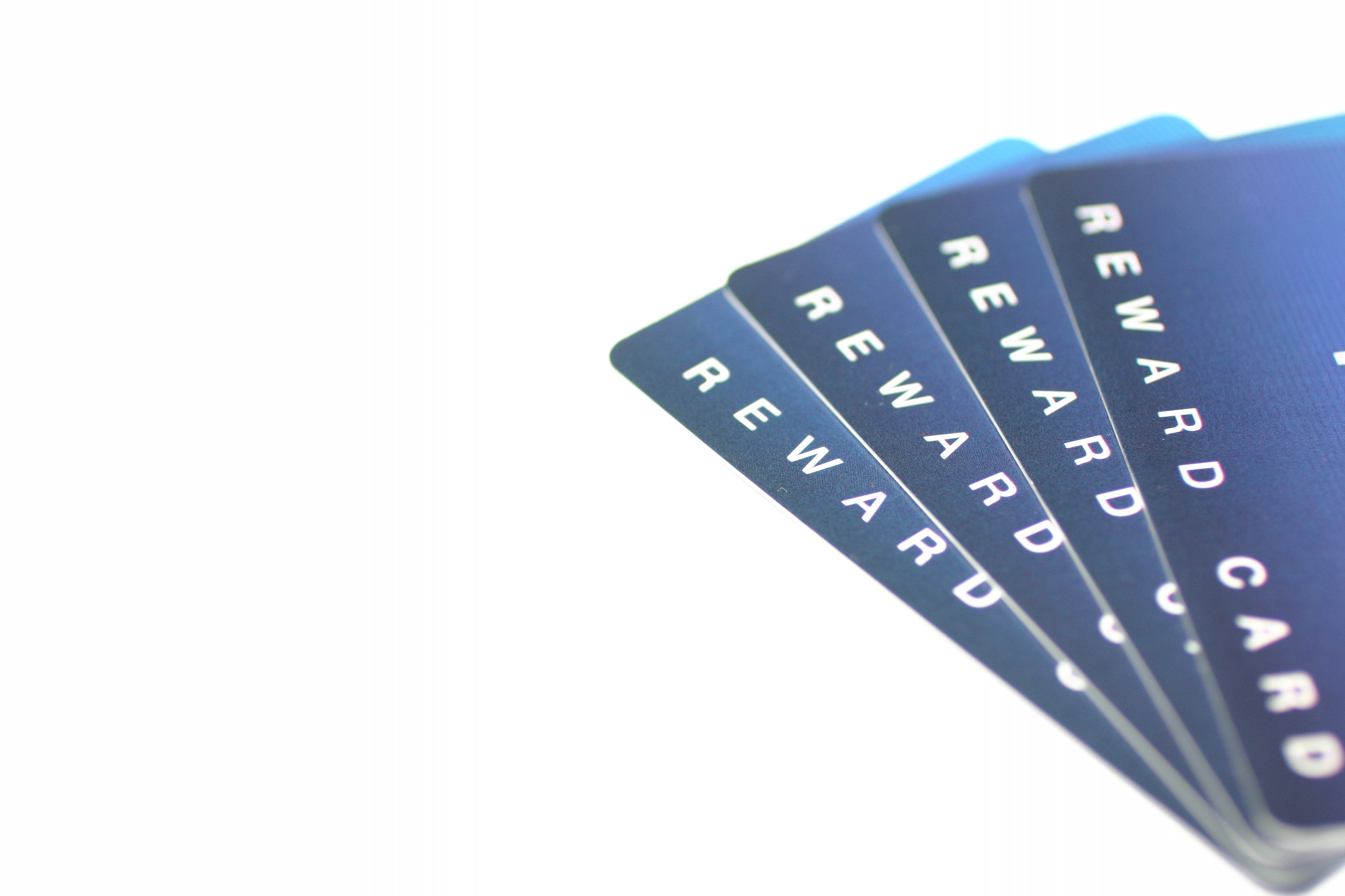  A close-up image of a stack of blue credit cards with the words 'Reward Card' on them.