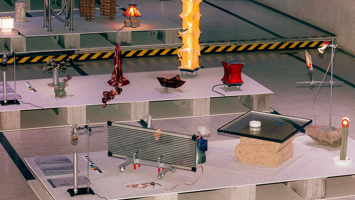 Experimental designs challenge standards An exhibition of various experimental designs arranged on raised platforms.