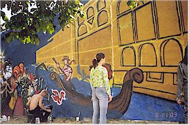 These artists were painting a mural on the side of a building