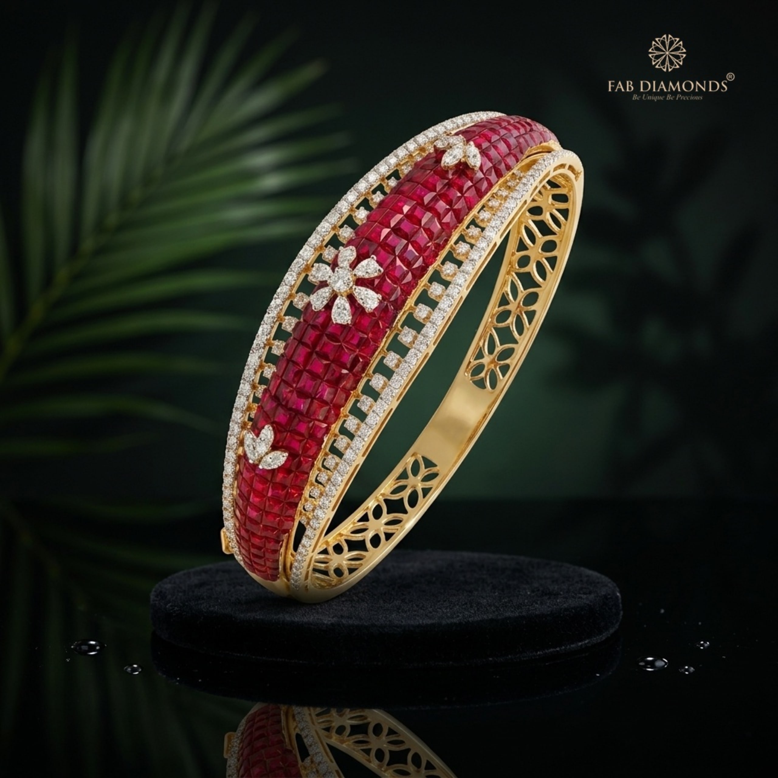 An 18KT yellow gold kada with invisibly set square rubies and a diamond flower center