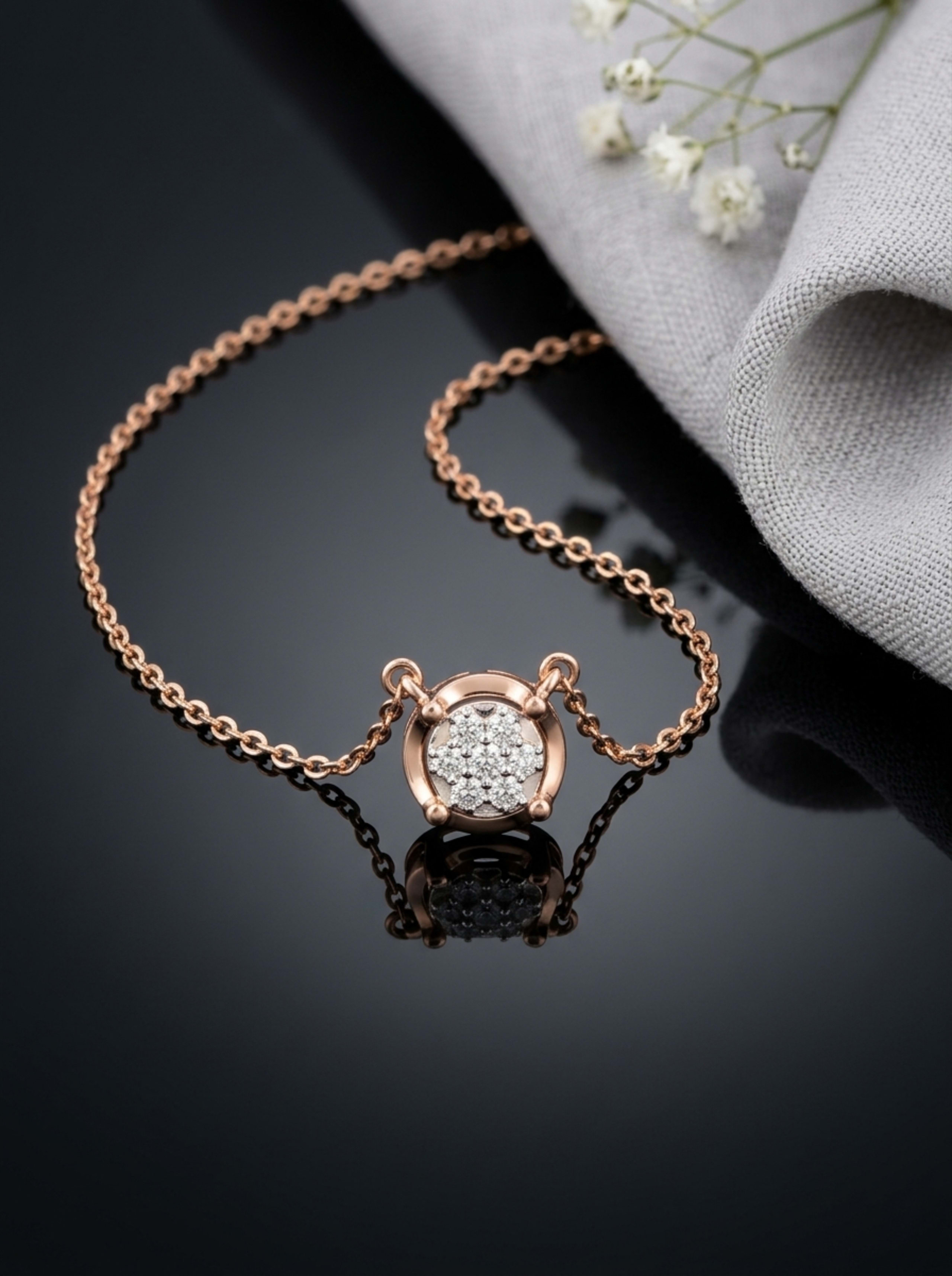 Solitaire Floral Cluster Button Pendant Chain in 18KT rose gold on glossy black surface