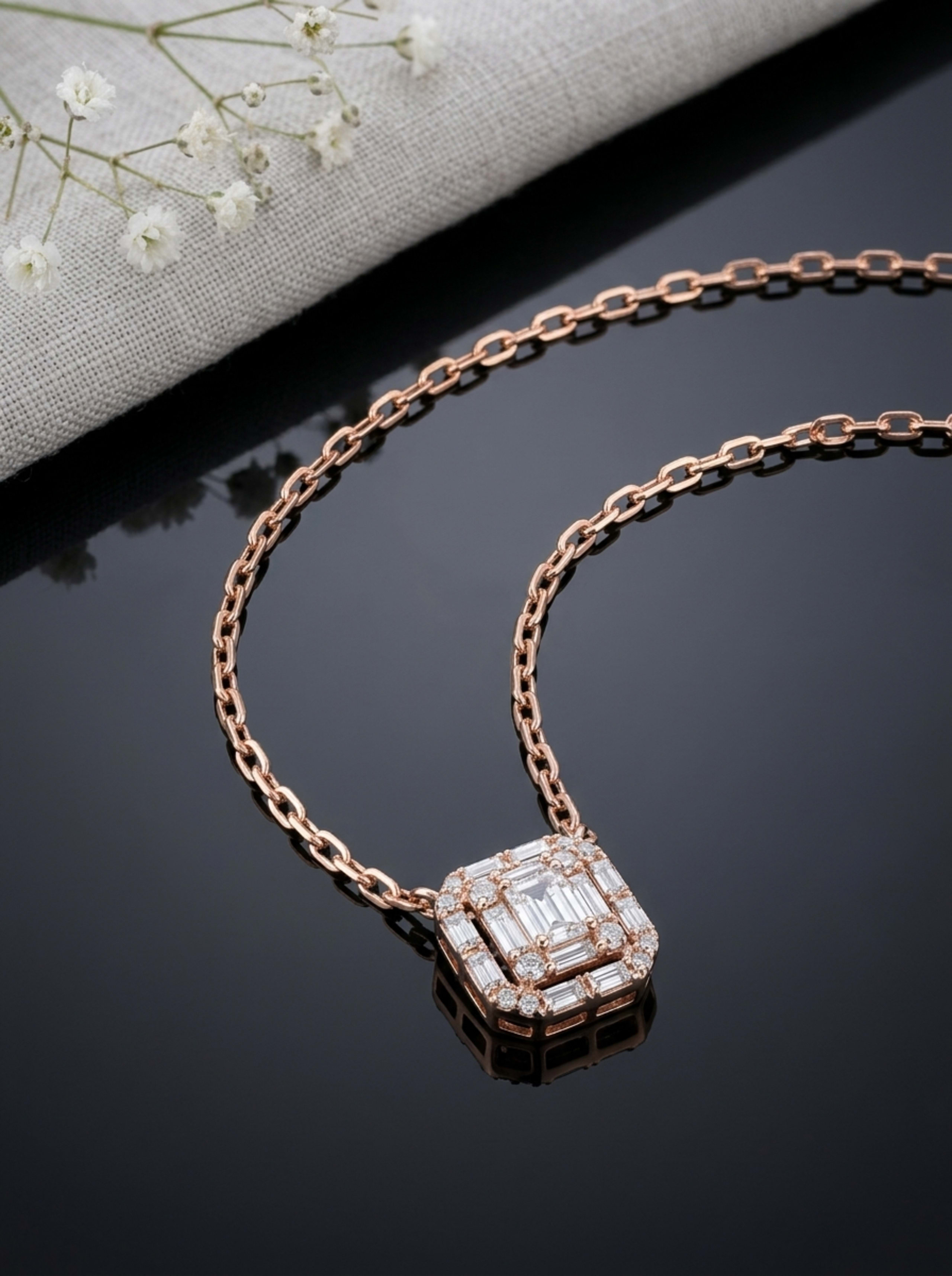 Baguette Halo Octagonal Paperclip Chain in 18KT rose gold on glossy black surface
