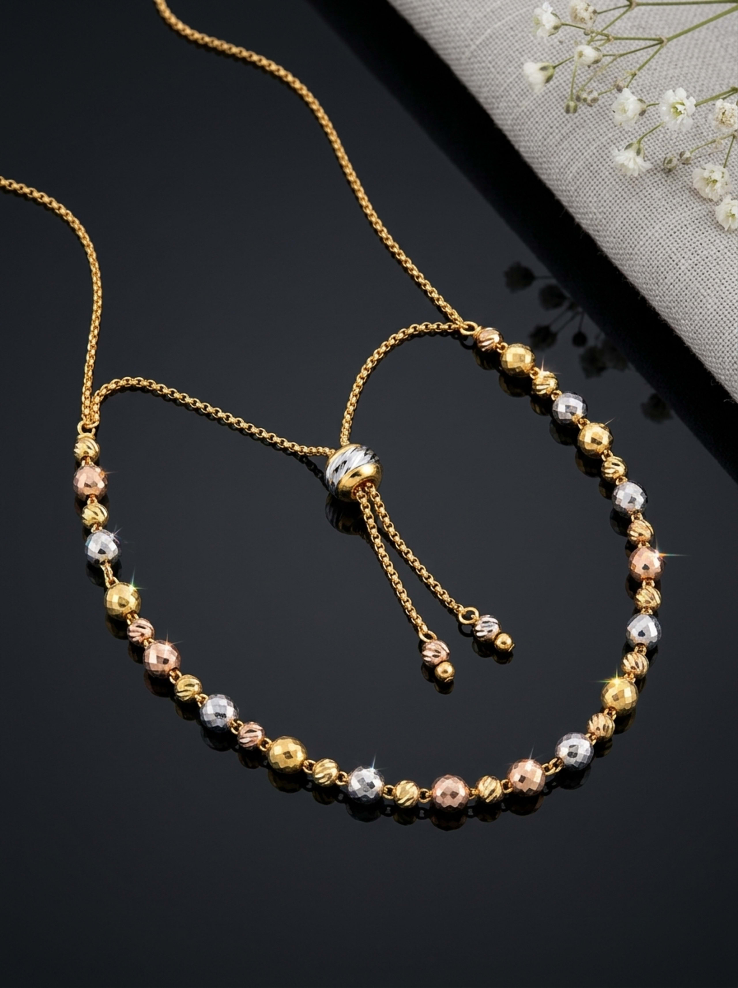 Indo-Italian Faceted Bead Bolo Slider Chain on glossy black surface
