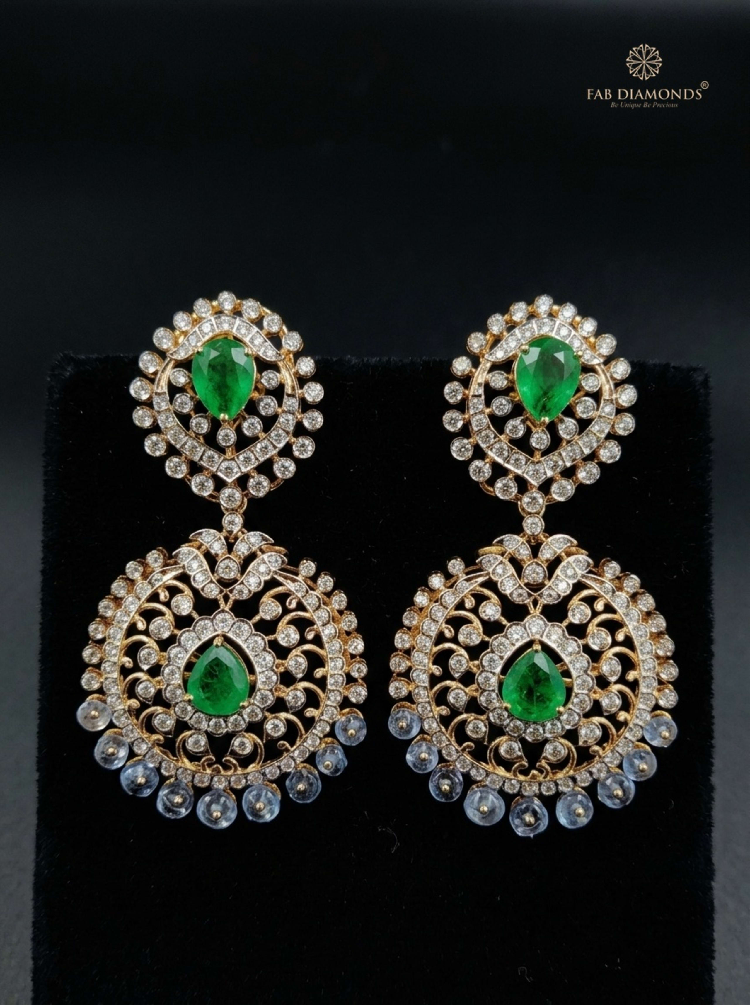 Pear Emerald Swirl Chandbali with Briolette Fringe on sunlit travertine pedestal