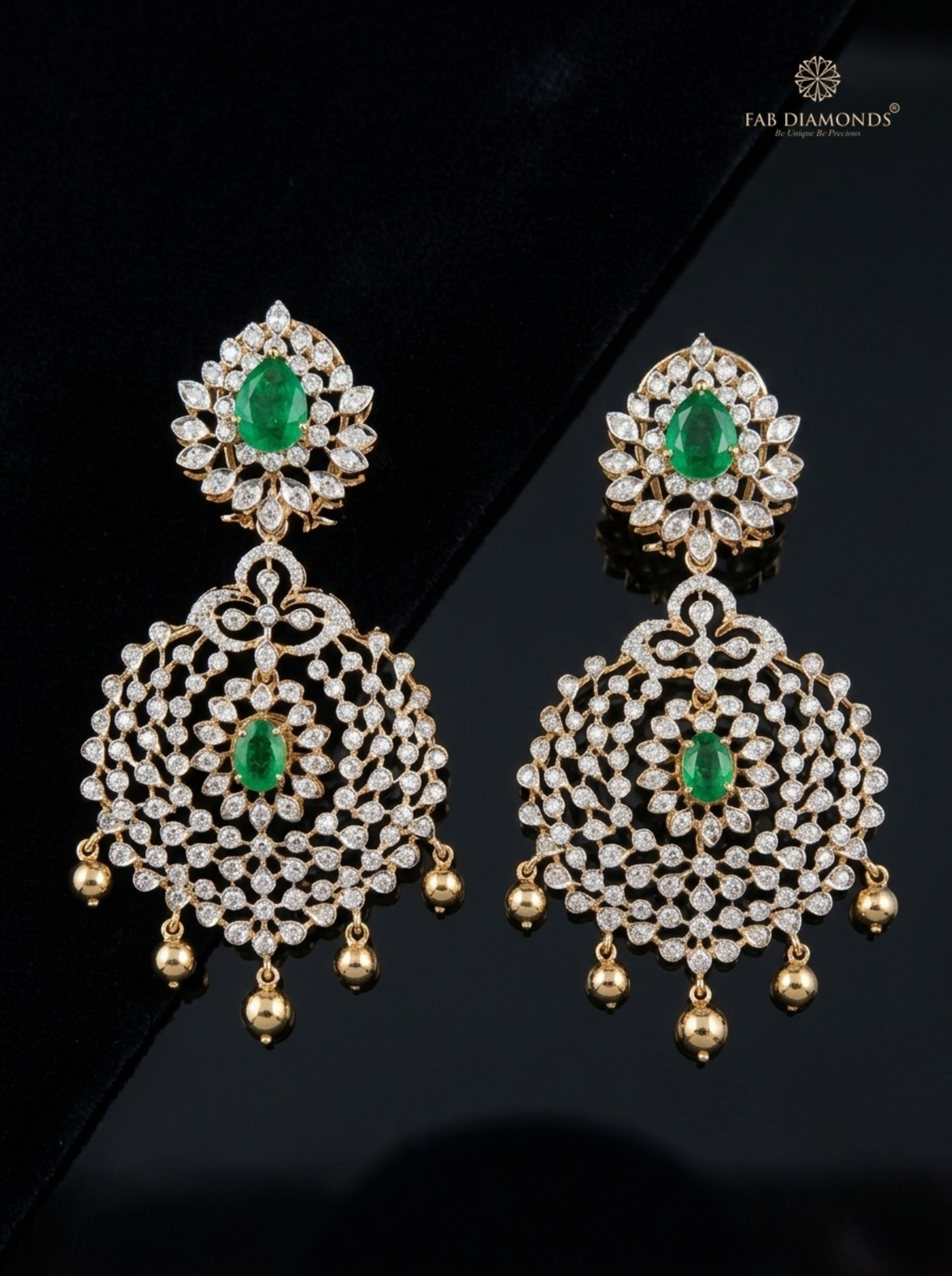 Zambian Pear Emerald and South Sea Pearl Chandelier Earrings on matte black surface