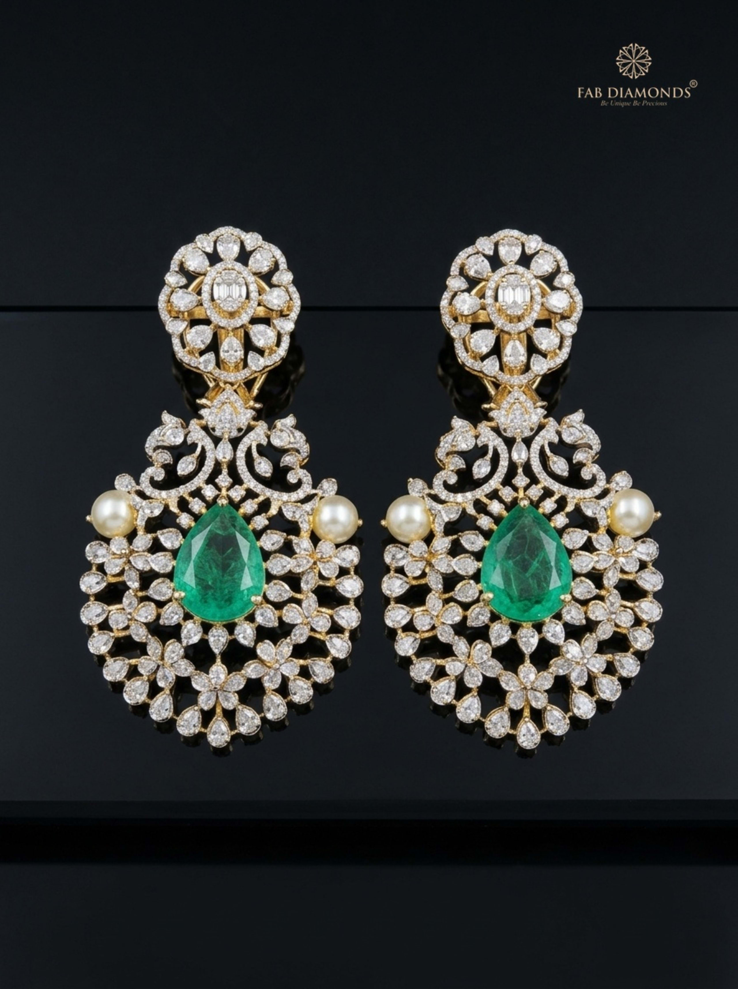 Octagonal Emerald Starburst Radiant Drop Earrings on silk cushion