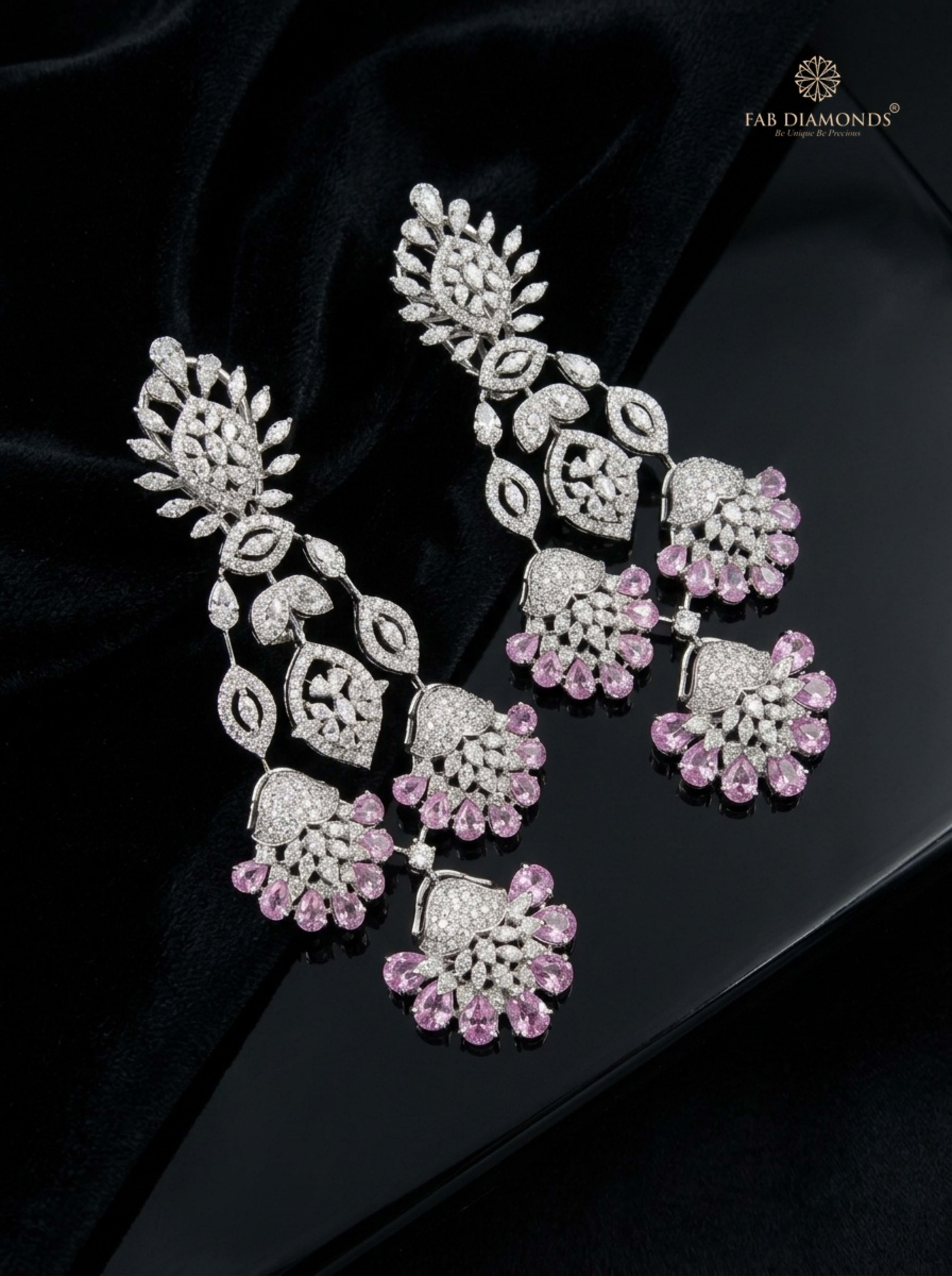 Pink Sapphire and Diamond Radiant Medallion Drop Earrings on sunlit travertine pedestal