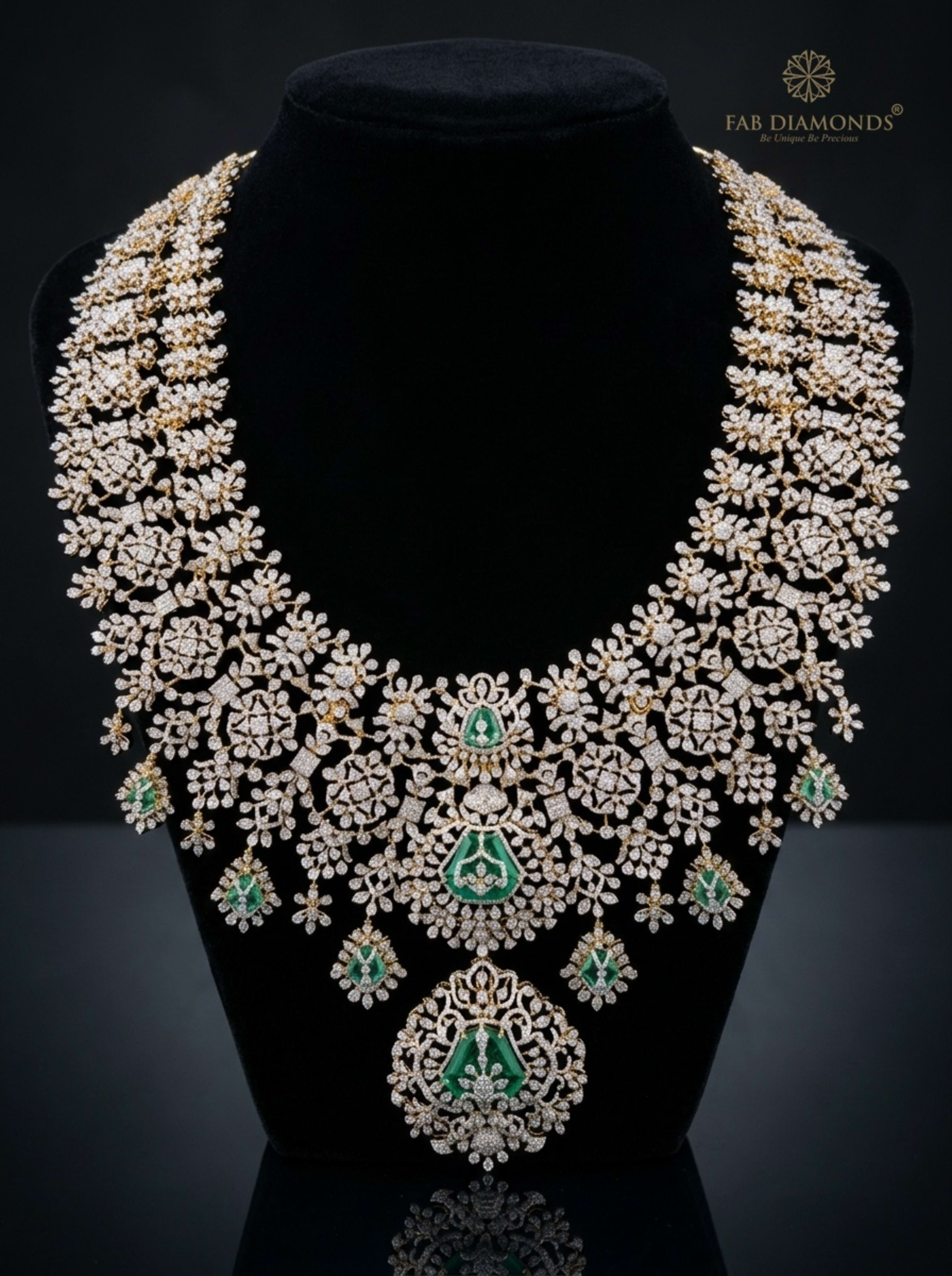 Floral Diamond Lace Haram with Shield-Cut Colombian Emeralds on reflective plinth with gold FAB logo