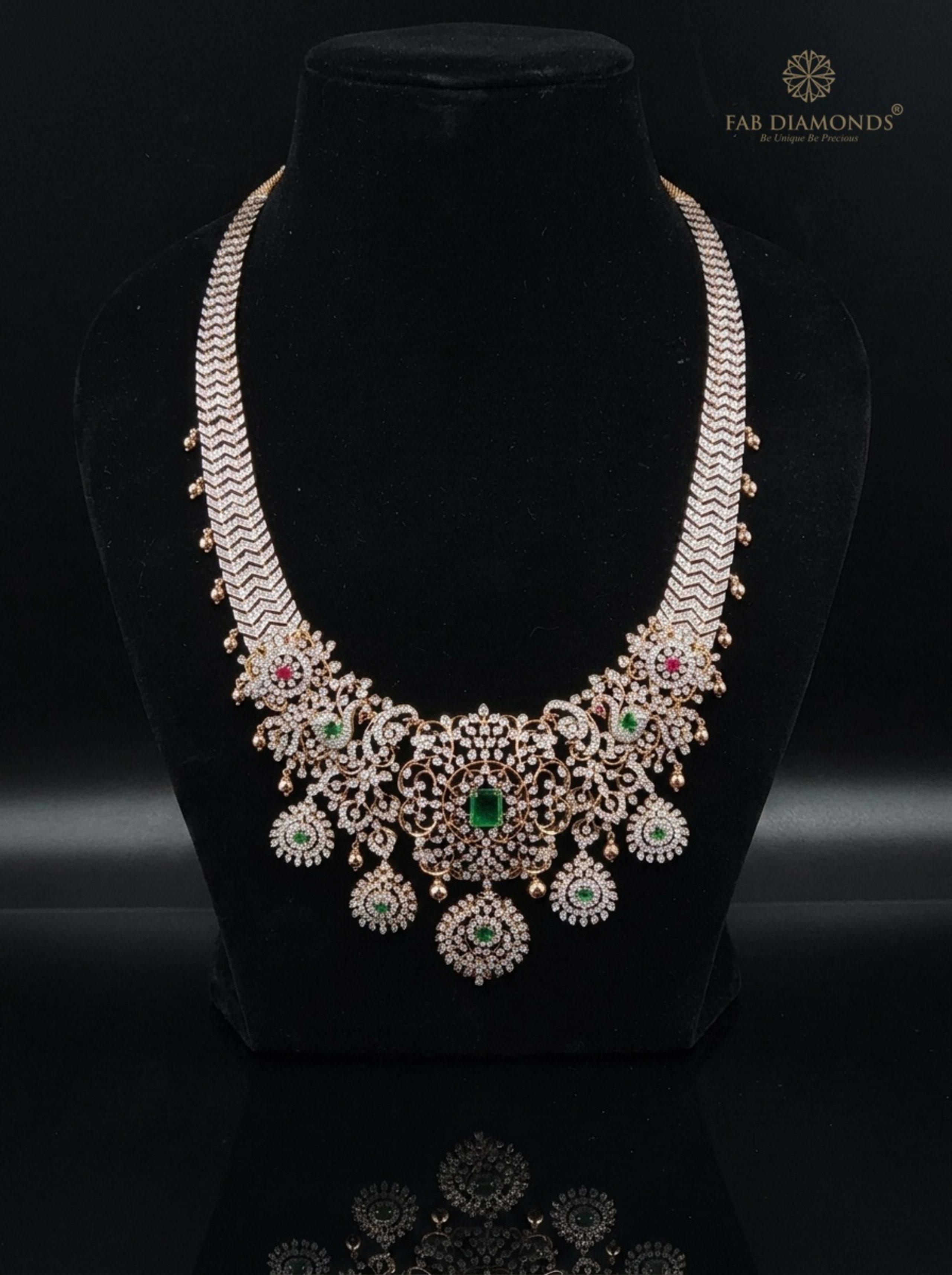 Triple Chevron Diamond Collar with Dancing Peacock Filigree on reflective plinth with gold FAB logo