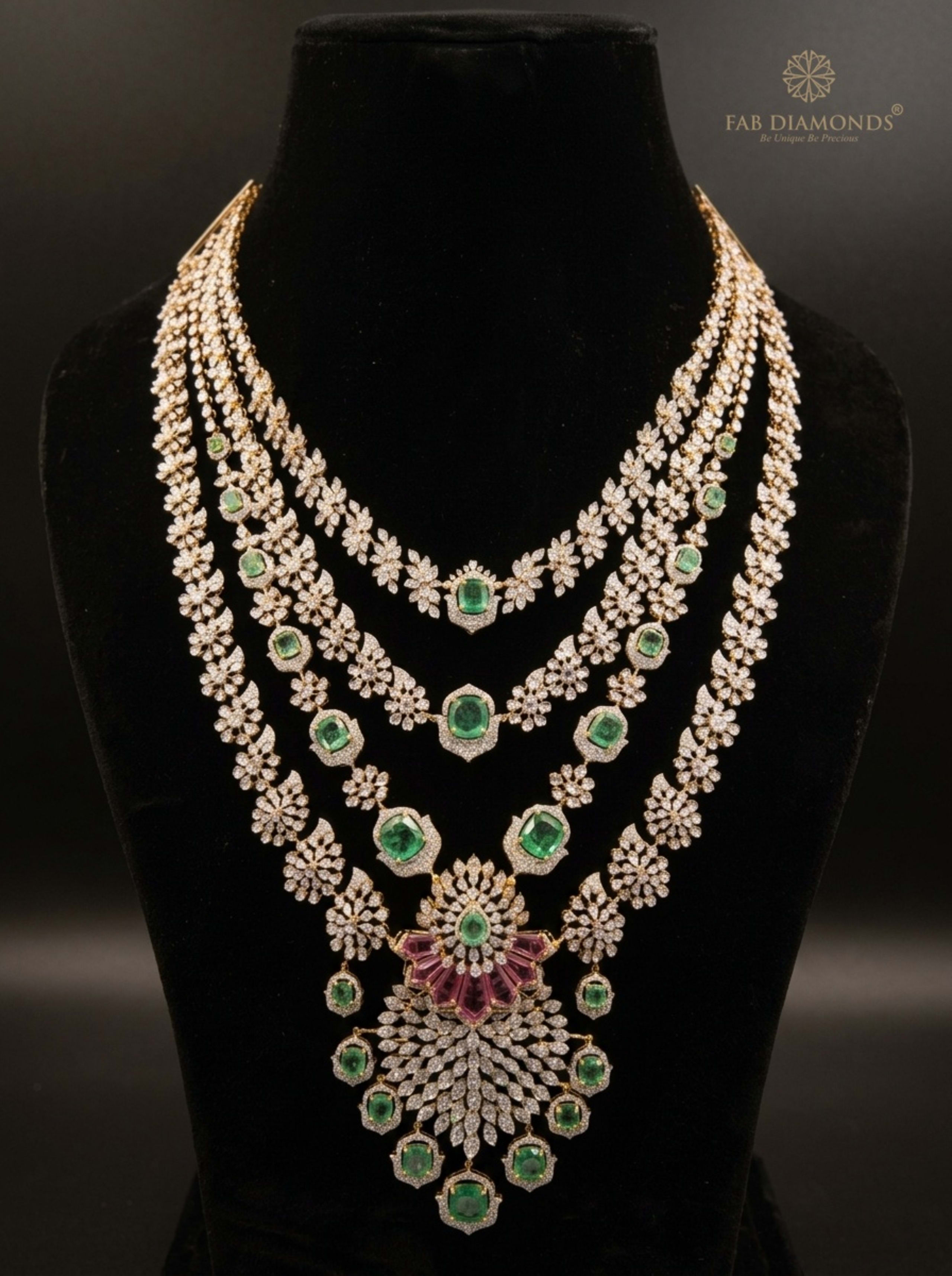 Graduated Three-Tier Diamond Strand Haram with Baguette Fan Pendant on velvet bust with gold FAB logo