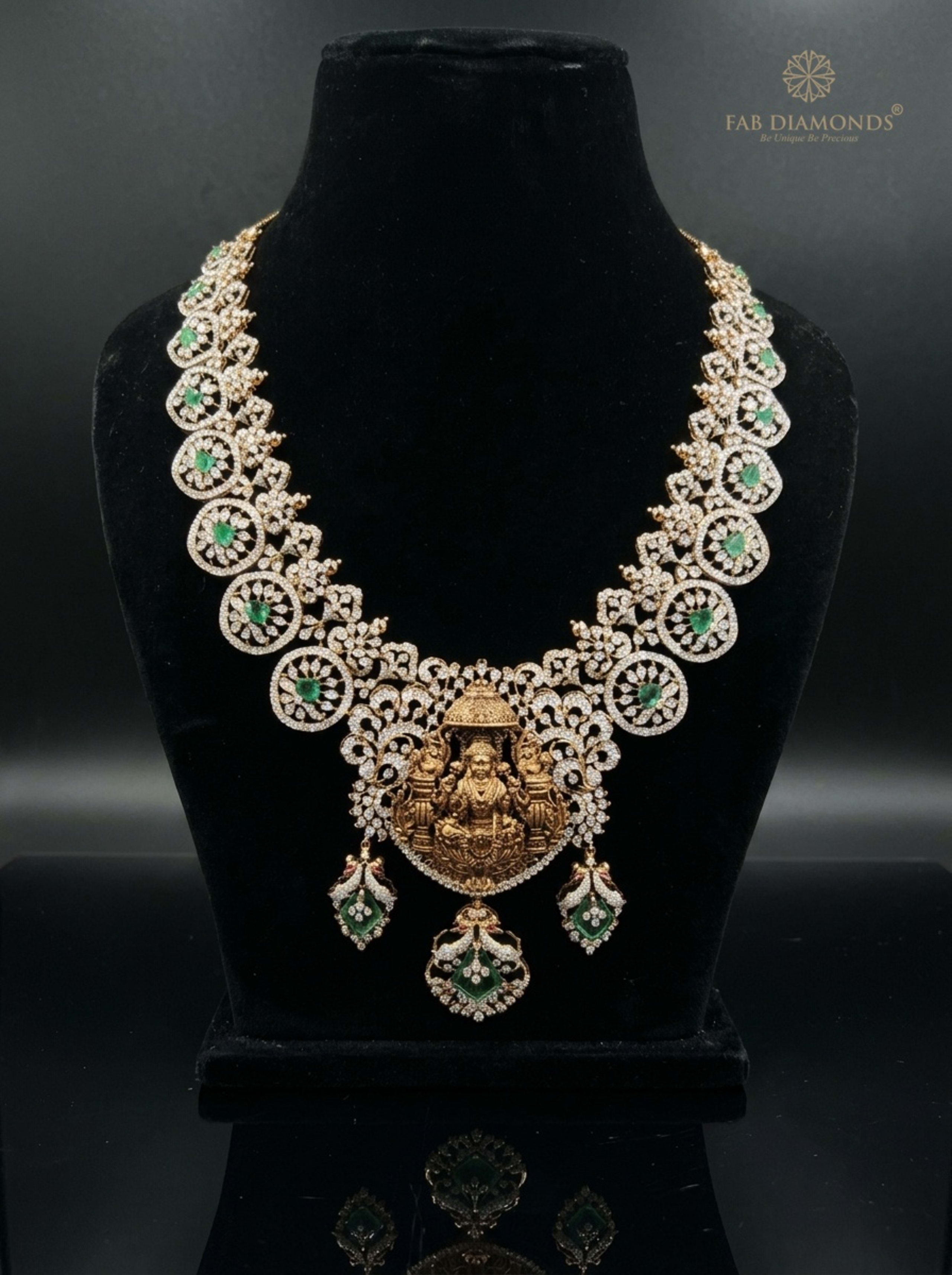 Chakra Diamond Wheel Haram with Goddess Lakshmi Temple Nakshi Idol on reflective plinth with gold FAB logo