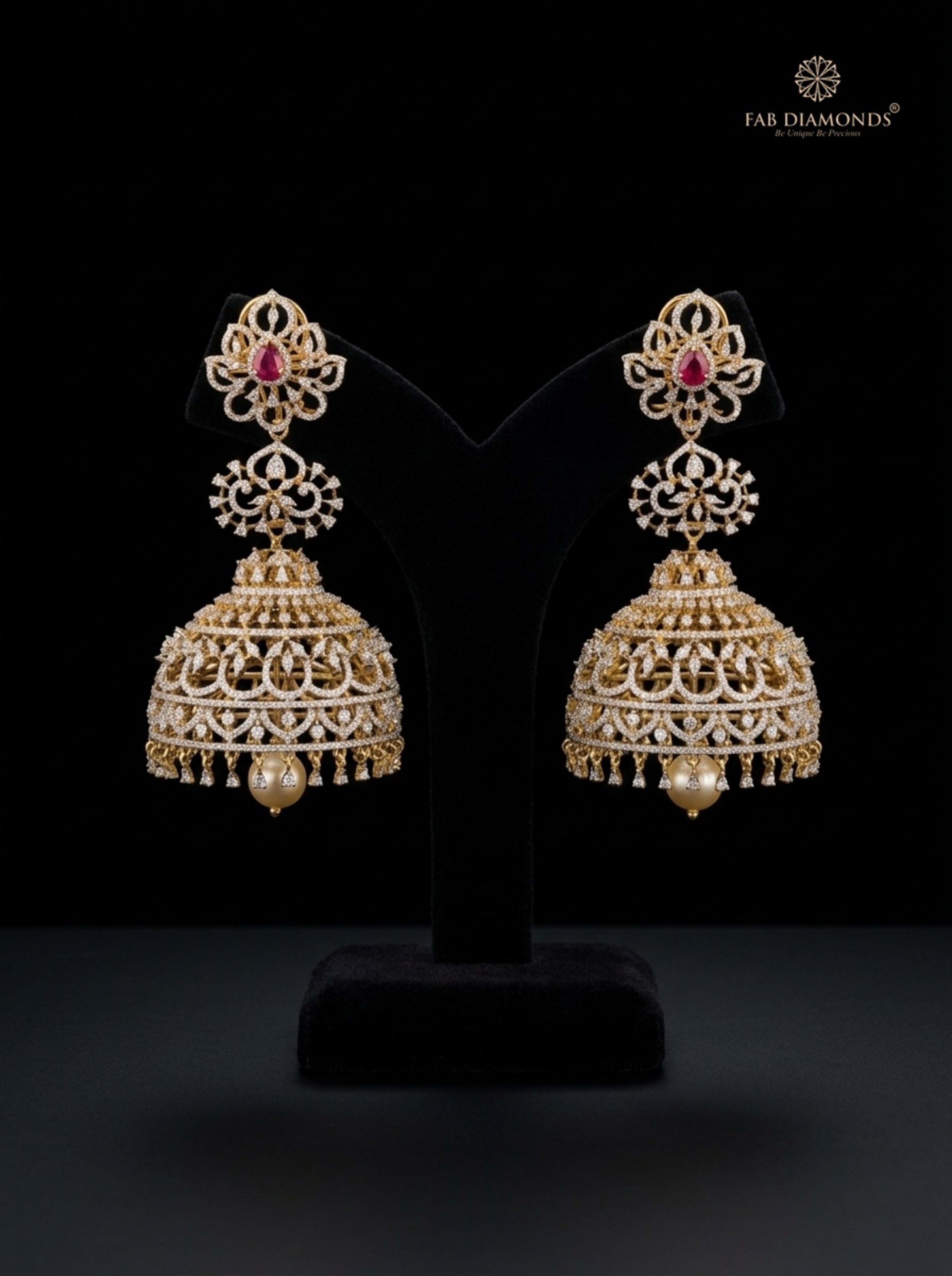 A pair of Madhuri arched filigree diamond jhumkas on slate rock pedestals