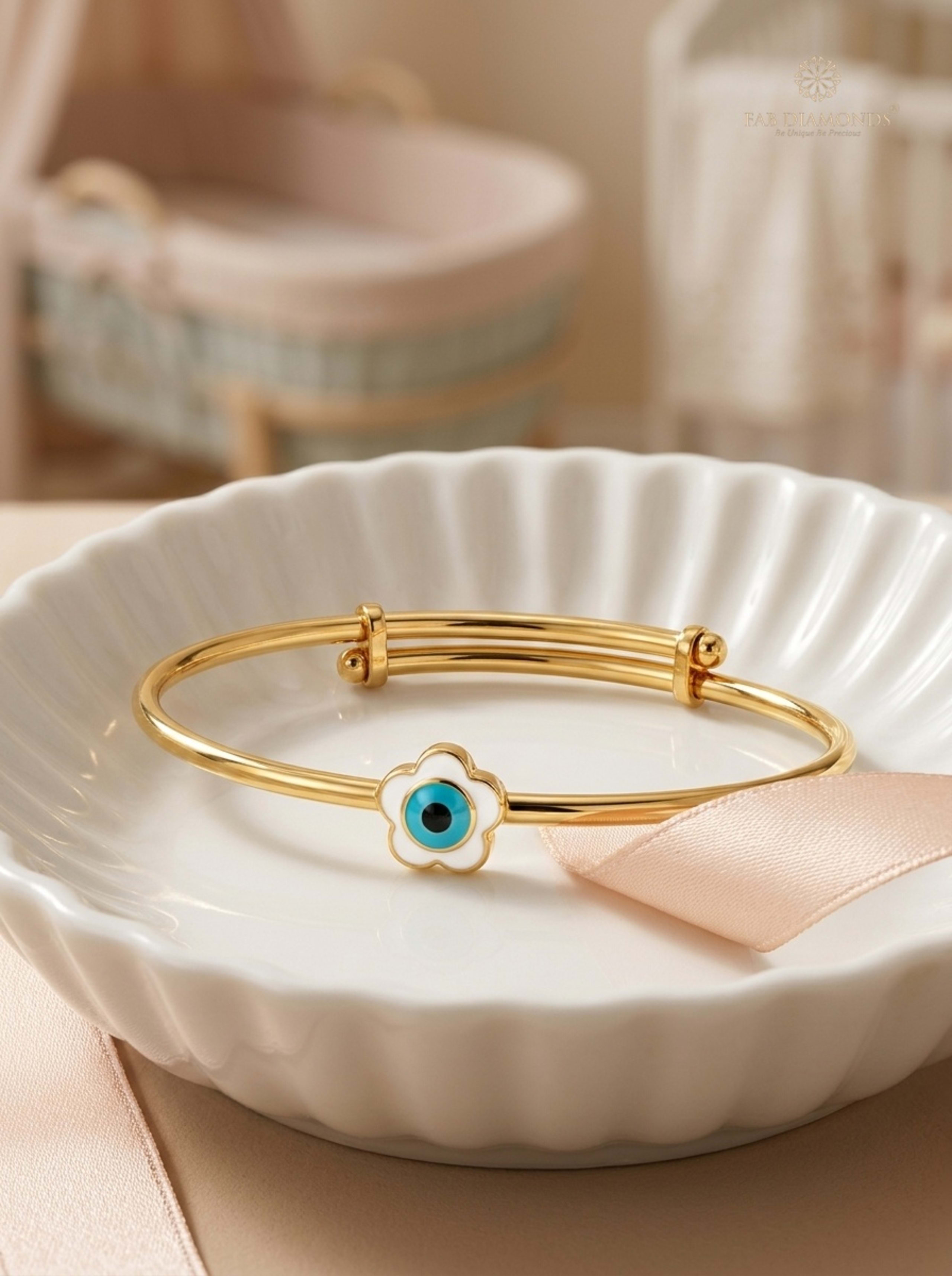 Nazar Battu Floral Evil Eye Expandable Baby Kada on fluted white ceramic dish